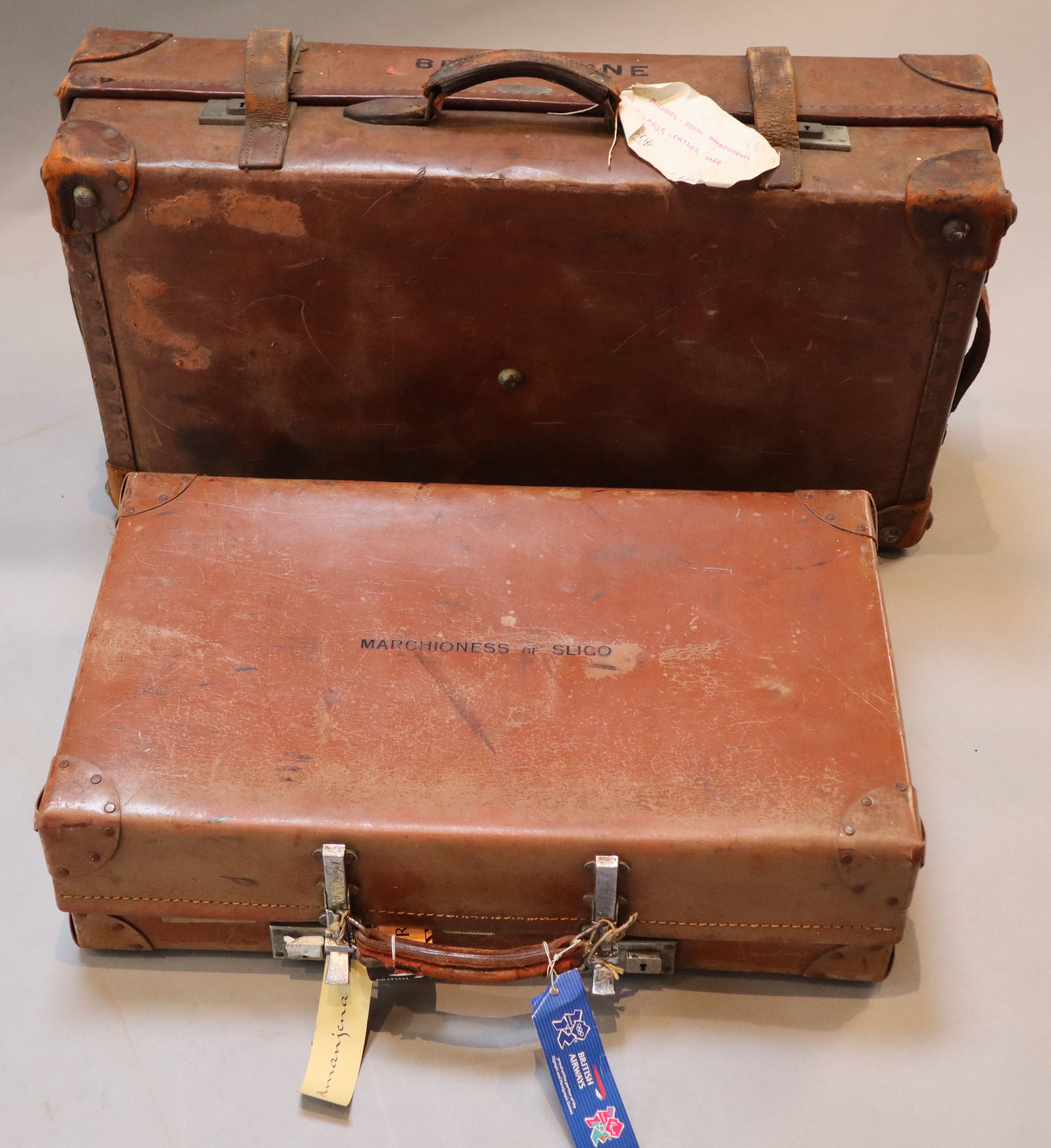 A group of three tan leather suitcases, one inscribed Brabourne, another Marchioness of Sligo